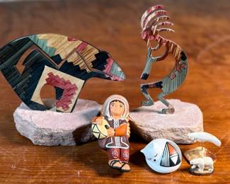 This lot features a curated collection of Native American items including sculptures, Acoma potttery, and more.


