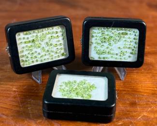 This lot features three (3) containers full of various sizes and cuts of peridot gemstones.

