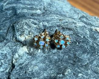 This lot features a pair of stunning 14k gold earrings, each containing seven (7) opals, circa 1940s. Total approx. weight of 2.58 grams.

