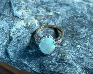 This lot features a stunning 14k gold ring with genuine diamonds and a large opal center stone. The ring has a mix of both yellow and white gold, comes in a size 5 with a total approx. weight of 4.71 grams.

