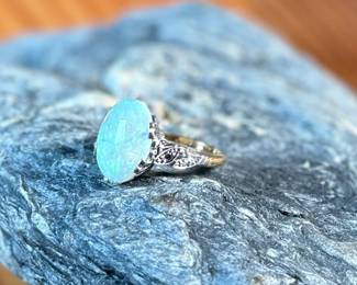 This lot features a stunning 14k gold ring with genuine diamonds and a large opal center stone. The ring has a mix of both yellow and white gold, comes in a size 5 with a total approx. weight of 4.71 grams.

