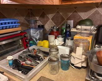 Small kitchen appliances including toaster and microwave ovens, slow cooker, food processors, coffee makers. 