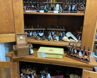 Tremendous selection of pipes, pipe stands, and related items including humidors!