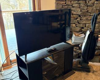 Flat screen TV, entertainment console, vacuum 