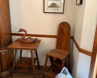 Parlor table, antique ironing board, wooden swan, art prints