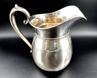 Sterling silver water pitcher has the hallmark of Manchester Silver Co. Pitcher has dents on lower half; 8.5"H, 554g.