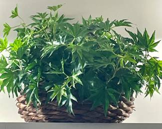 FAUX FOLIAGE IN RATTAN BASKET