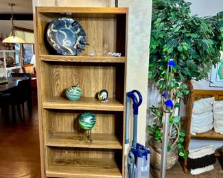 Glassworks, bookcase, vacuum, floor lamp