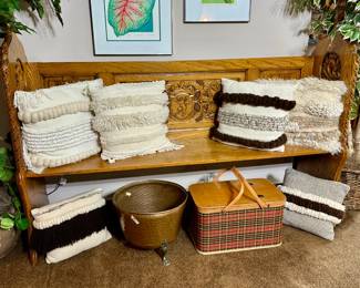 Antique church pew, decorative pillows, framed art