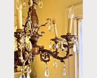 Vintage Hollywood Regency brass and crystal chandelier in working condition with built in light dimmer