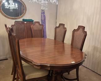 This breathtaking dining table comes with 2 armchairs, 4 chairs, 2 leaves, table pads, and even extra upholstery for the seats on the chairs!