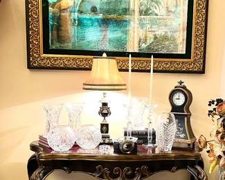 Matching pictures, console table, lamps and floral arrangement