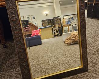 Stunning mirror with gilt detail and carved floral frame