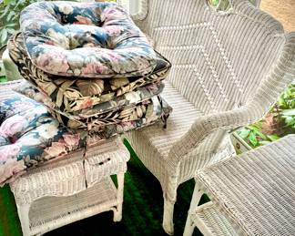 This photo features mainly the beautiful White wicker loveseat, coffee table, 2-tier larger side tables, and the available cushions