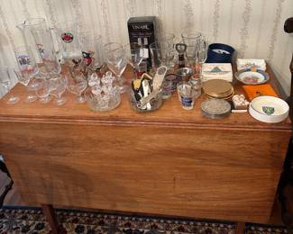 Large Gate-Leg Dropleaf Table; collection of vintage barware and openers; beautiful Persian wool rug on Diningroom floor beneath