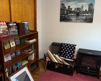 Books, bookshelves, rolled up prints/maps, travel trunks (more in lower basement area), electric fireplace heater