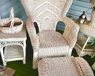 Features 1 of the 2 wicker armchairs, with the single ottoman, flanked by the round 2-tier accent table with lamp, and one of the pair of square 2-tier side table