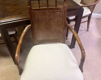 Close up of the chair. Cane back with brass casters.