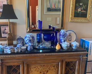 entrance table which becomes a wine storage cabinet filled with blue and white