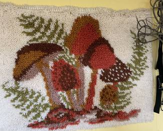 Rosenberg Estate Sale featuring a vintage latch hook rug or wall hanging with a charming mushroom design. A unique textile piece with playful, retro appeal.
