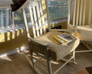 Rosenberg Estate Sale featuring white rocking chairs that have been kept indoors, complete with cushions. Clean, classic pieces perfect for a porch, nursery, or living space.