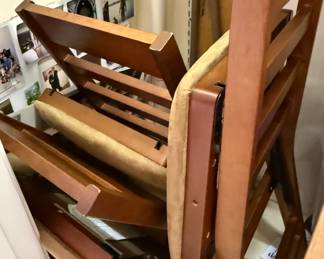 Stack of Foldable Ladder-Back Chairs With Upholstered Seats