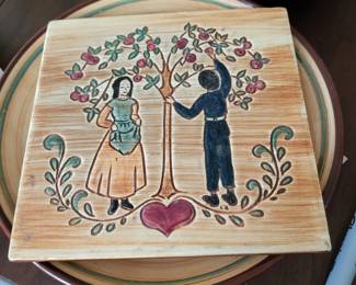 vintage Pennsbury Pottery Amish apple-picking wall plaque or trivet, likely produced between 1950 and 1970. 