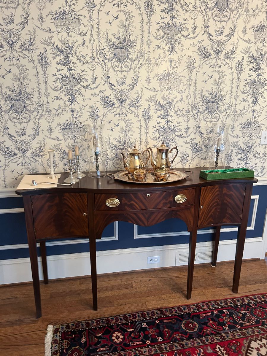 Madison Square mahogany with matched flame grain panels; Brass hardware is
original, locks work. The front has a graceful serpentine curve, the drawer has dovetail joints. A
silver cloth caddy inside is removable.  61.5"Wx 18" deep and 36"H.