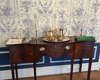 Madison Square mahogany with matched flame grain panels; Brass hardware is
original, locks work. The front has a graceful serpentine curve, the drawer has dovetail joints. A
silver cloth caddy inside is removable.  61.5"Wx 18" deep and 36"H.