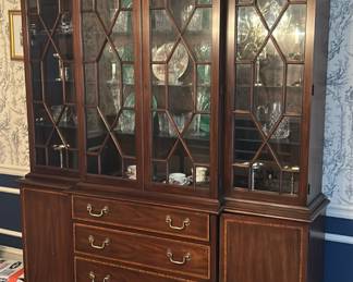 Henkle Harris china cabinet  featuring
dovetailed drawers w/ cross banded satinwood inlay fronts, original keys, brass hardware,
lighted interior, individual pane doors and adjustable glass shelves. Inside each drawer is the
Henkel Harris branded insignia w/ the top drawer being cloth lined for flatware tarnish
protection.&nbsp;Dimensions : 66”w x 18”d x 78.5"h (two bulbs burned out). 2 PIECES