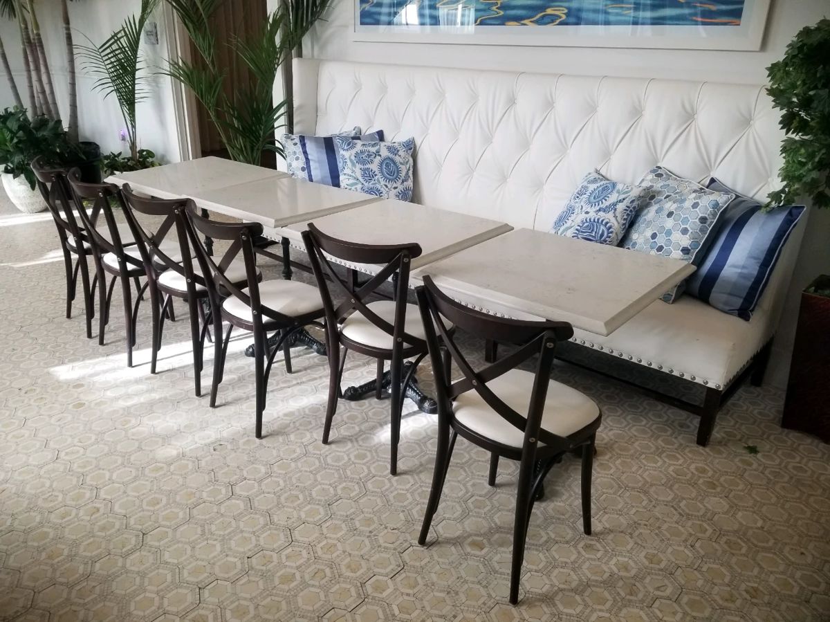 Tufted banquette and bistro chairs - 7 chairs available. Banquette is 9 feet, 10 inches long x 52 inches tall x 28 inches deep. Square marble top tables are 27 inches x 27 inches x 31 inches tall. 4 table left. Banquettes $595 each. Bistro chairs $65 each. Tables $195 each