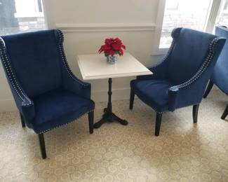 Upholstered chairs with studs - 4 chairs available. Marble top square tables with wrought iron bases - 4 tables left. Square marble top tables with wrought iron bases are 27 inches x 27 inches x 31 inches tall. Chairs $275 each. Tables $195 each