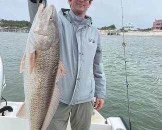Here’s a photo of me with a big ol’ Redfish! Caught just a little south of Lake Waubesa.