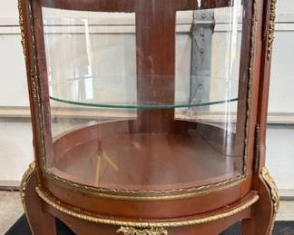 Solid wood round curio cabinet.  https://modestlambestatesales.hibid.com/