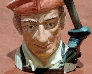 Several Royal Doulton toby face large size jugs / pitchers in this auction.  This one is a blacksmith with hammer and anvil.  