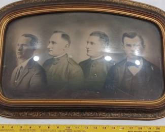 antique bubble glass frame with hand colored photo of 4 men circa world war 1 era, maybe brothers. 