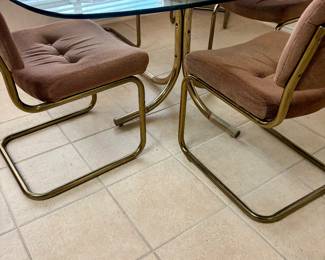 Smoky glass table with cantilever chairs. 