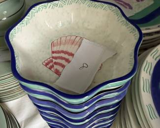 This is a set of dinnerware from the Ernest Hemingway Collection, featuring a shell pattern. The collection includes plates and bowls with colorful, hand-painted designs of shells in various colors such as purple, orange, and pink 30 Pieces many different shell patterns.