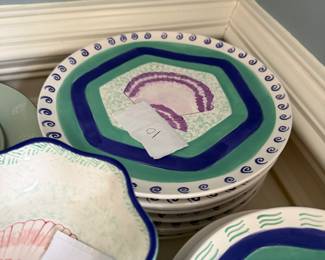 This is a set of dinnerware from the Ernest Hemingway Collection, featuring a shell pattern. The collection includes plates and bowls with colorful, hand-painted designs of shells in various colors such as purple, orange, and pink 30 Pieces many different shell patterns.