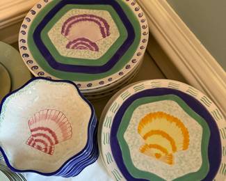 This is a set of dinnerware from the Ernest Hemingway Collection, featuring a shell pattern. The collection includes plates and bowls with colorful, hand-painted designs of shells in various colors such as purple, orange, and pink 30 Pieces many different shell patterns.