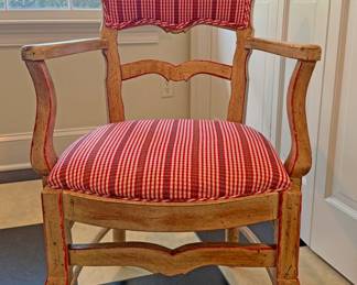Round glass-top dining table with a sculptural base and a set of four matching vintage wooden armchairs with  upholstered cushions