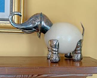 Elephant sculpture featuring an authentic ostrich egg