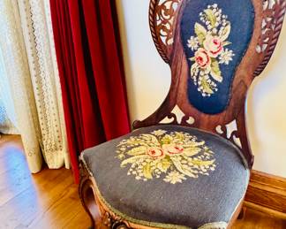 Antique Victorian -style parlor chair exceptional carving around high back and think constructed of Rosewood with fine needlepoint seat and back