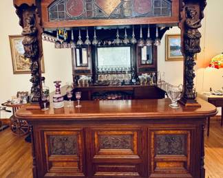 Classic canopy english pub bar with stained glass windows, hand painted tiles, wine glass racks, etched mirrors, shelves, drawers and storage for all your valuable bottles. 
