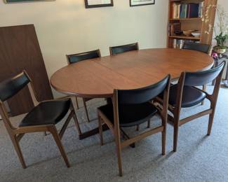 MCM dining table with 3 leaves and 6 black faux leather chairs. Scandia Imports!