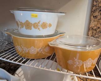 Vintage Pyrex Butterfly Gold casserole dishes with lids.
