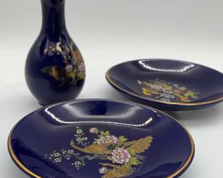 Cobalt blue porcelain bud vase And Plates with gold rim, featuring peacocks and floral designs.