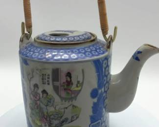 Vintage Japanese blue and white porcelain teapot with wicker handle.