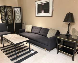 Mid century vibe living room. Lots of black lacquer tables, 3 panel screen, interesting art