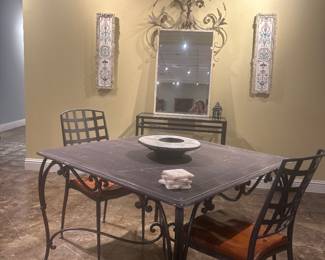 One of four French iron based garden tables with wooden composition top